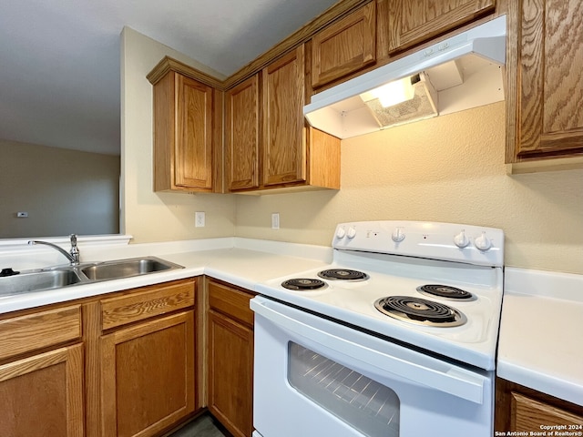 kitchen featuring sink and white range with electric stovetop