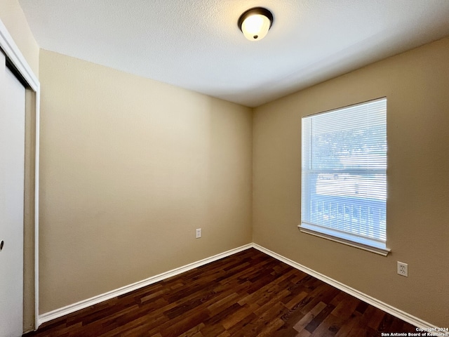 spare room featuring dark hardwood / wood-style flooring