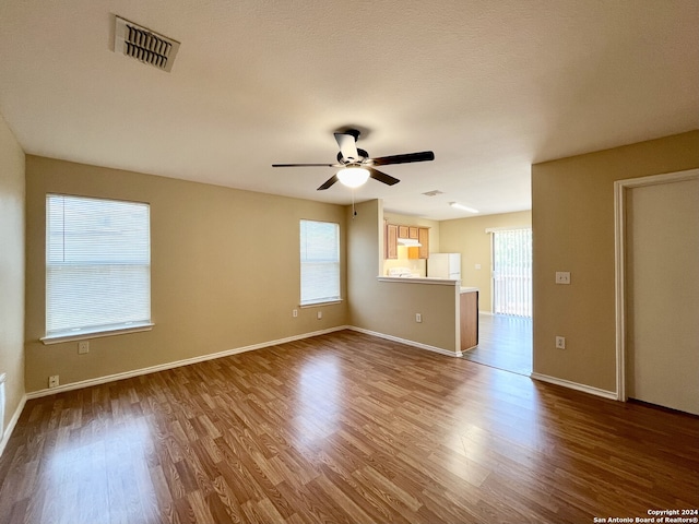 empty room with hardwood / wood-style flooring and ceiling fan