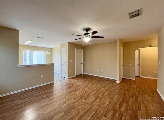 empty room featuring ceiling fan and wood-type flooring