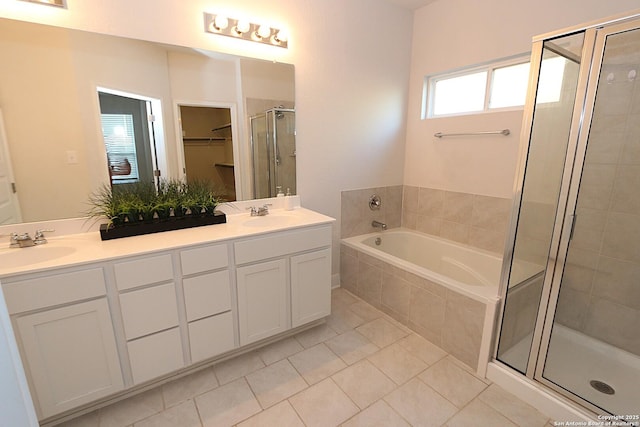 bathroom with tile patterned flooring, plus walk in shower, and vanity