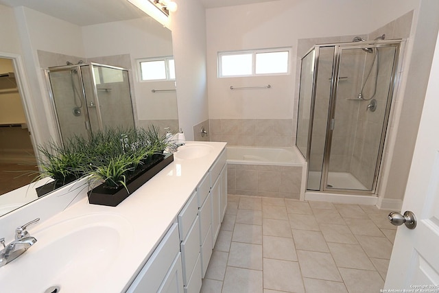 bathroom with tile patterned flooring, vanity, and plus walk in shower