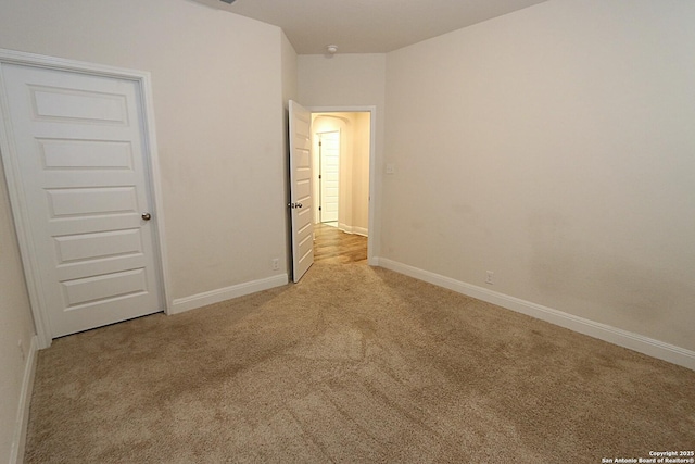 unfurnished bedroom with light carpet