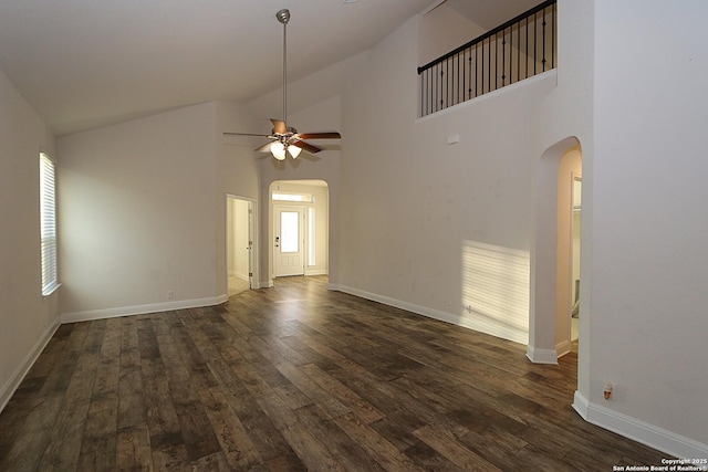 unfurnished living room with ceiling fan, dark hardwood / wood-style flooring, and high vaulted ceiling