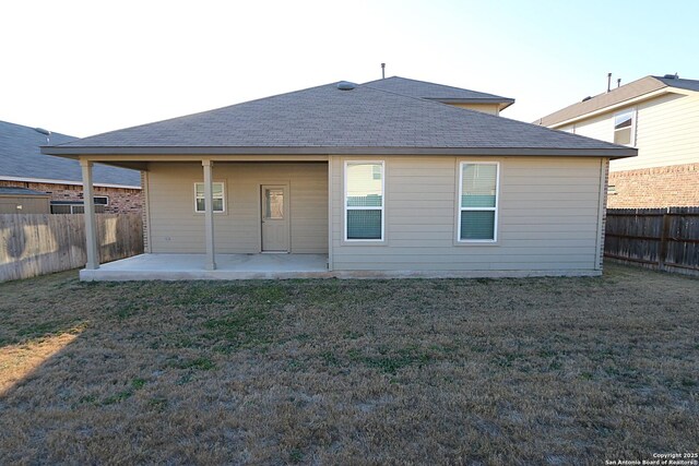 back of property featuring a lawn and a patio area