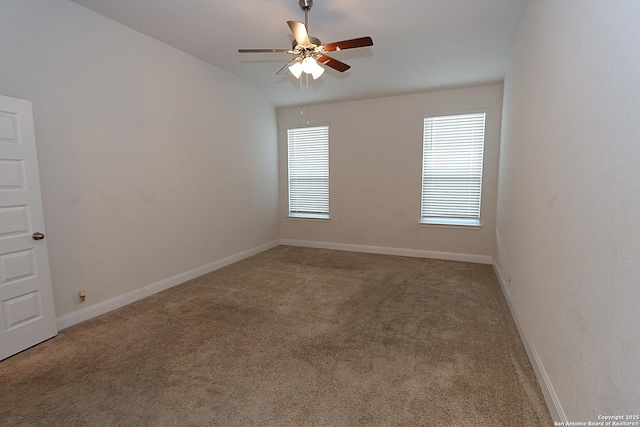 carpeted spare room featuring ceiling fan