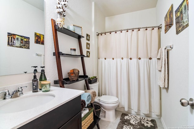 bathroom featuring vanity, tile patterned floors, and toilet