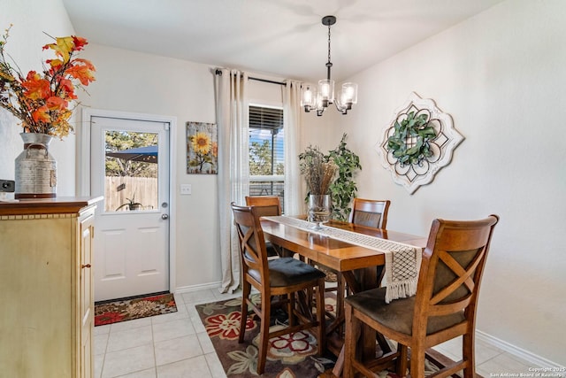 tiled dining room featuring a notable chandelier