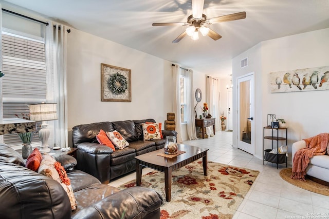 tiled living room with ceiling fan