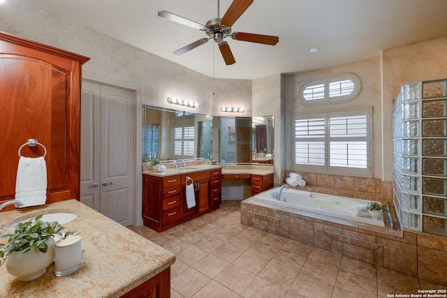 bathroom featuring vanity, tiled tub, tile patterned flooring, and ceiling fan