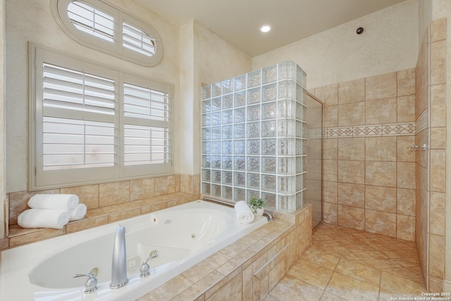 bathroom featuring plenty of natural light, tile patterned floors, and independent shower and bath