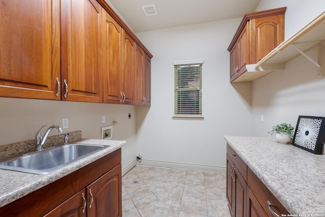 laundry room with hookup for a washing machine, sink, hookup for an electric dryer, and cabinets