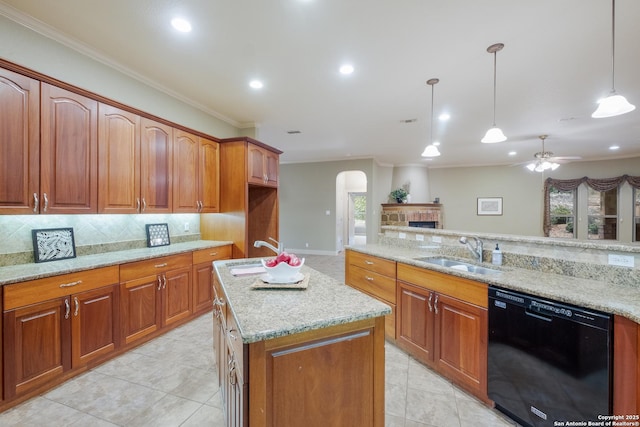 kitchen with decorative light fixtures, black dishwasher, sink, and light stone countertops