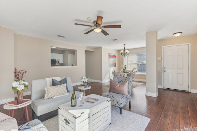 living room featuring dark hardwood / wood-style floors and ceiling fan with notable chandelier