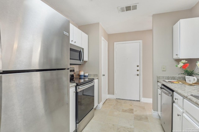 kitchen with appliances with stainless steel finishes and white cabinets