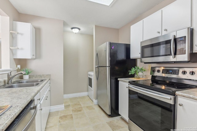 kitchen featuring sink, stainless steel appliances, and white cabinets