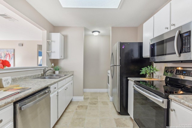 kitchen featuring white cabinetry, sink, and appliances with stainless steel finishes