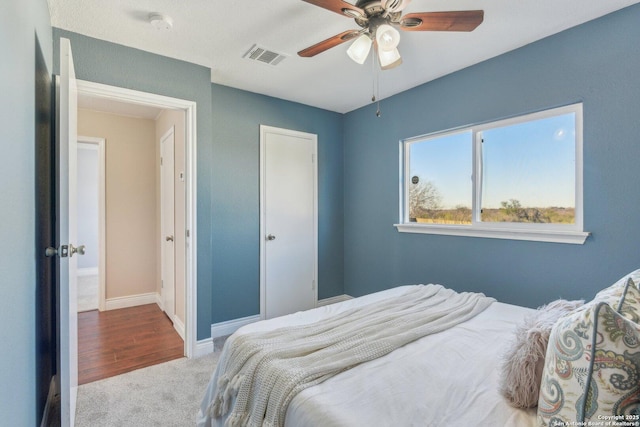 carpeted bedroom with ceiling fan