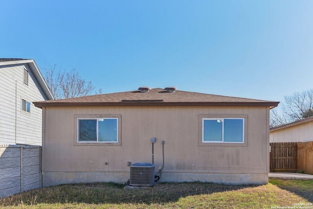 view of side of home featuring a yard and central air condition unit