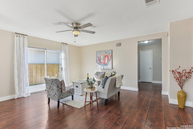 living room featuring dark wood-type flooring and ceiling fan