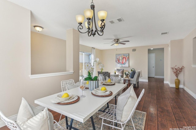 dining room featuring dark hardwood / wood-style flooring and ceiling fan with notable chandelier