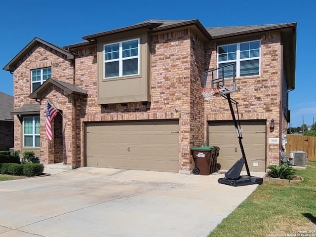 prairie-style house with central AC unit and a garage