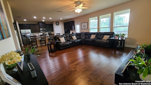 living room featuring dark hardwood / wood-style floors and ceiling fan