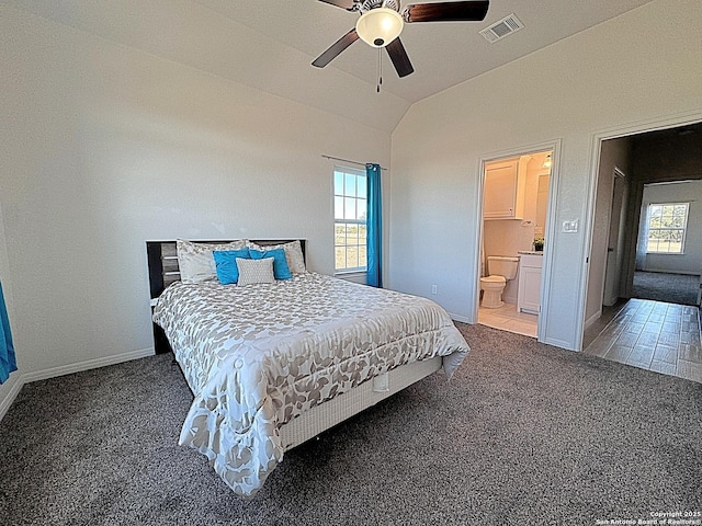 carpeted bedroom with ensuite bathroom, lofted ceiling, and ceiling fan