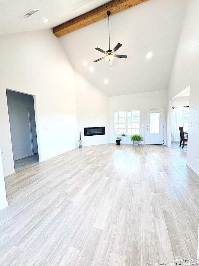 unfurnished living room featuring beam ceiling, light hardwood / wood-style flooring, high vaulted ceiling, and ceiling fan