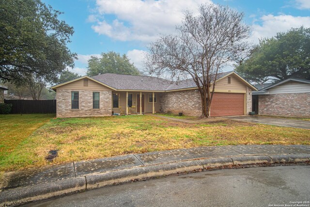 ranch-style home with a garage and a front yard