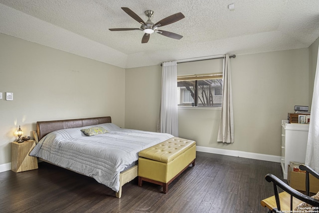 bedroom with lofted ceiling, ceiling fan, dark wood-type flooring, and a textured ceiling