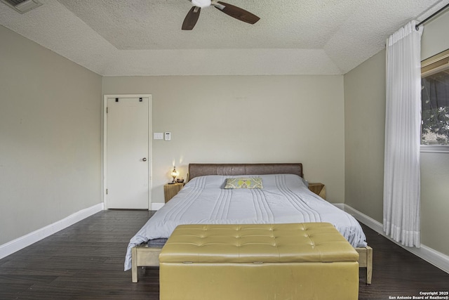 unfurnished bedroom featuring ceiling fan, dark hardwood / wood-style floors, and a textured ceiling