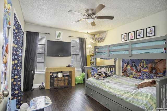 bedroom with dark hardwood / wood-style floors and a textured ceiling