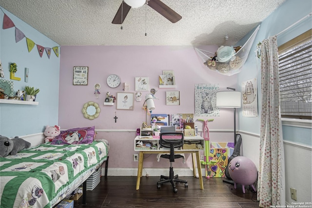 bedroom with ceiling fan, dark hardwood / wood-style floors, and a textured ceiling