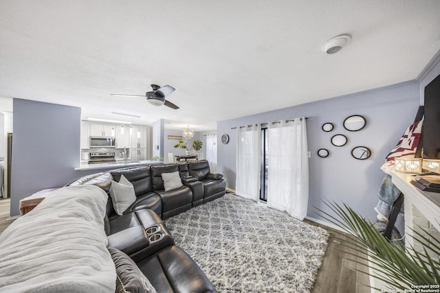 living room featuring hardwood / wood-style flooring and ceiling fan