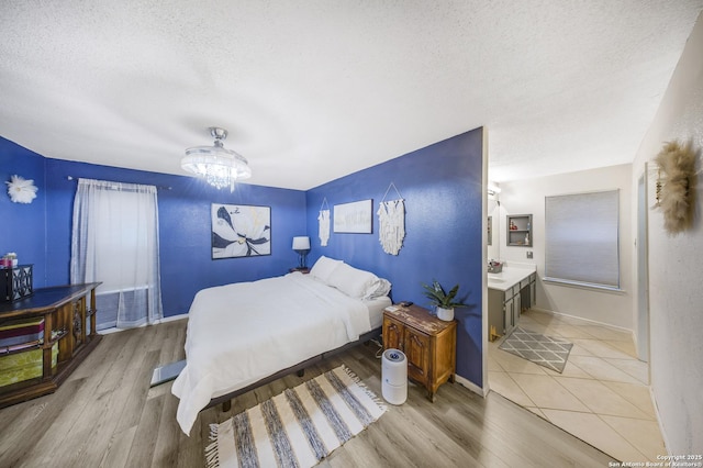 bedroom featuring light hardwood / wood-style floors and a textured ceiling