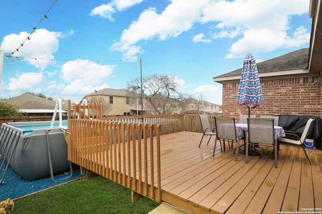 deck featuring a fenced in pool