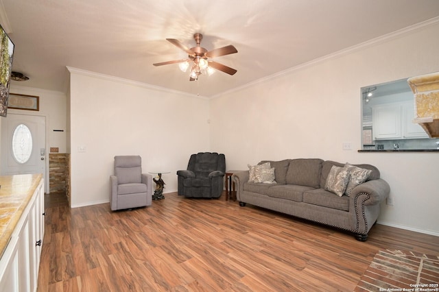 living room featuring hardwood / wood-style flooring, crown molding, and ceiling fan