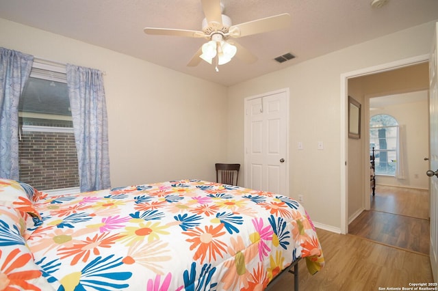 bedroom with ceiling fan and light wood-type flooring