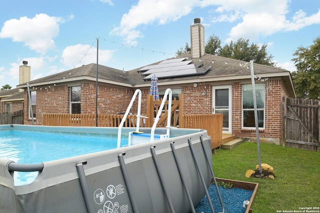 view of pool with a lawn