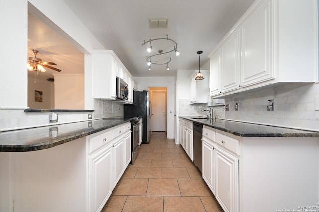 kitchen with white cabinetry, kitchen peninsula, and appliances with stainless steel finishes