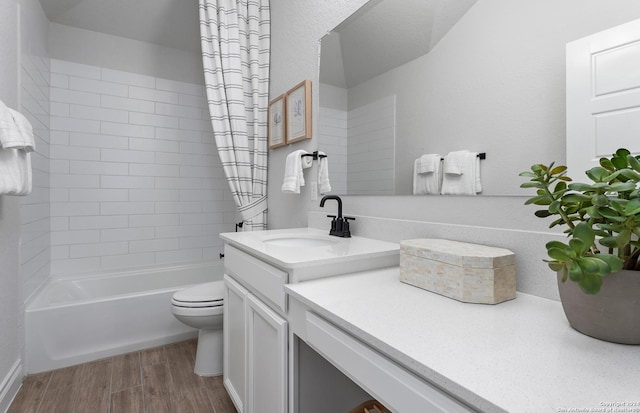 full bathroom with shower / bath combo with shower curtain, wood-type flooring, toilet, and vanity