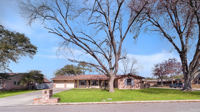 ranch-style home with a garage and a front yard