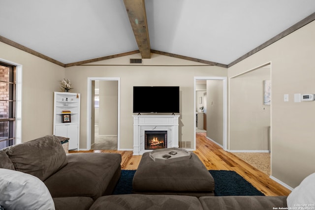 living room with lofted ceiling with beams and light wood-type flooring