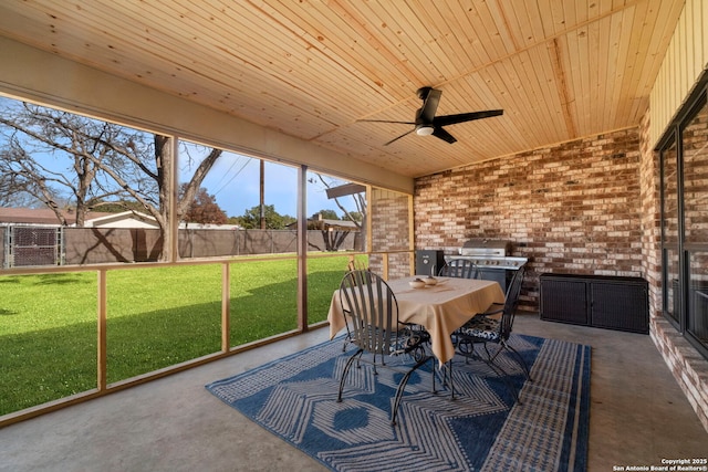 unfurnished sunroom featuring ceiling fan and wooden ceiling