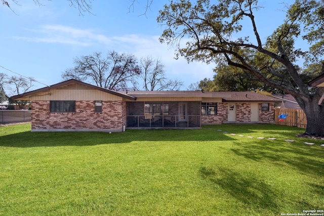 rear view of property featuring a yard