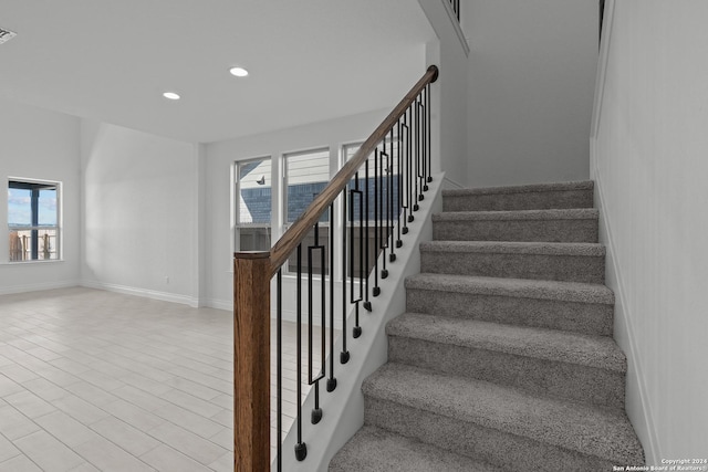 stairs featuring hardwood / wood-style floors