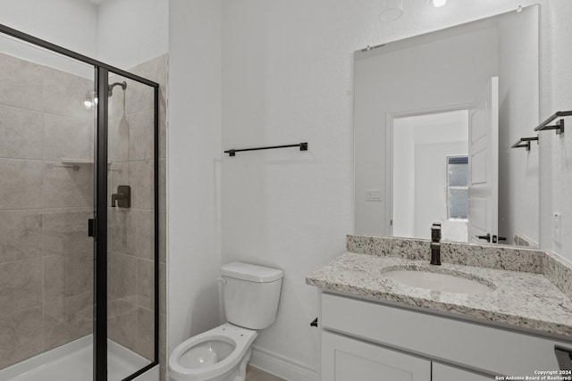 bathroom with vanity, walk in shower, and toilet