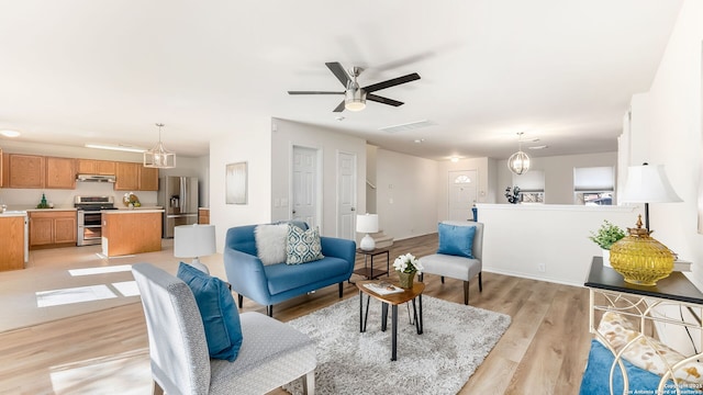 living room featuring light hardwood / wood-style flooring and ceiling fan