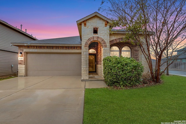 view of front facade with a garage and a lawn